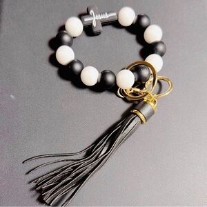 Black and White Beaded Bracelet with Tassel and Jesus cross.